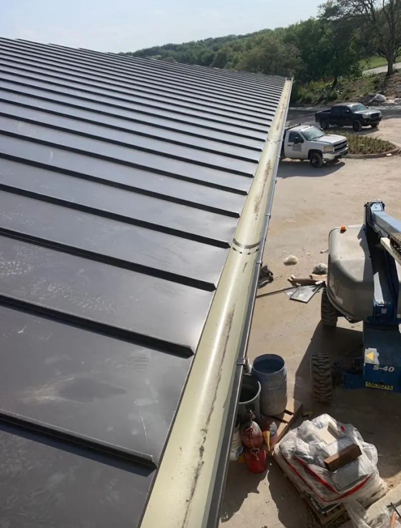 Standing seam panel and gutter detail on a metal roofing jobsite in Lyndhurst